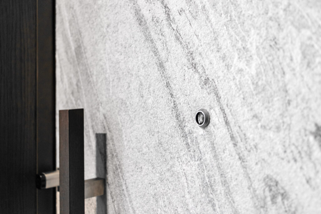 Realizacja drzwi wejściowych fornirem kamiennym SNOW STONE - detal drzwi